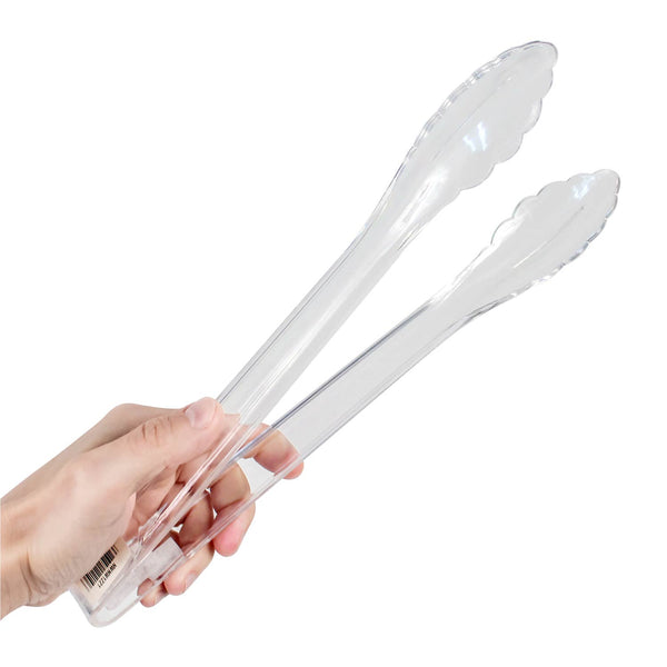 hand using clear tongs