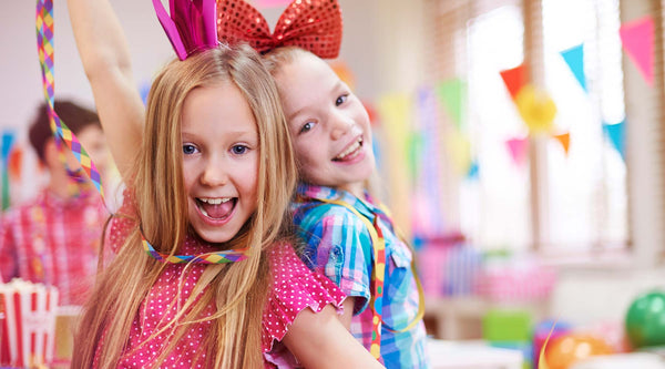two young girls celebrating at a party