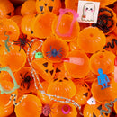 Assorted Halloween-themed toys and decorations in pumpkin containers